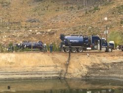 D&L trucks working along a reservoir bank