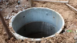 Concrete septic tank riser in an excavation