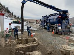 Hydrovac crew exposing a gas pipeline on a winter job site