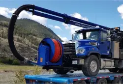D&L combination truck with its hose reel, loaded on a flatbed