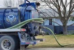 D&L septic truck pumping a tank at a home
