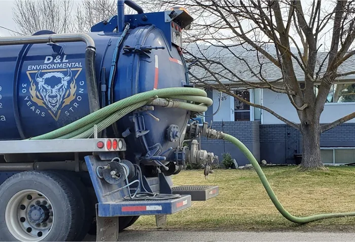 D&L septic truck pumping a tank at a home